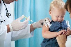 A doctor is giving a child an influenza vaccine.